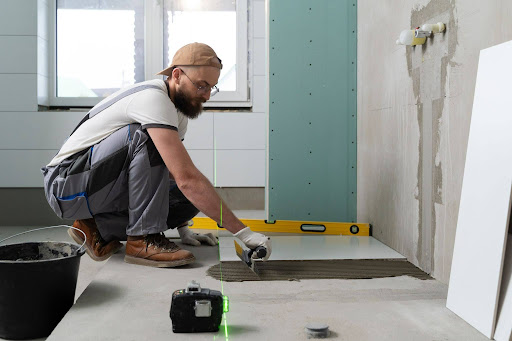 Contractor installing flooring during basement foundation repair<br />

